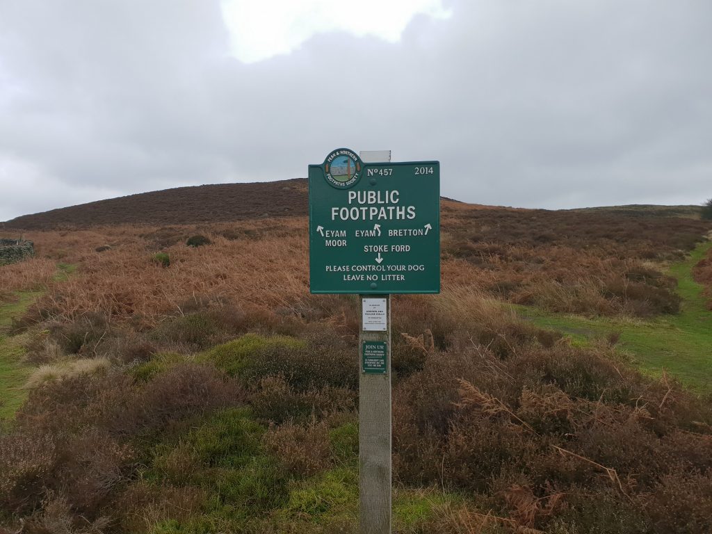 A Green public footpath sign on the Moors