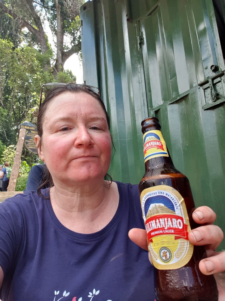 Me, drinking a beer at the end of the trek, looking rather tired