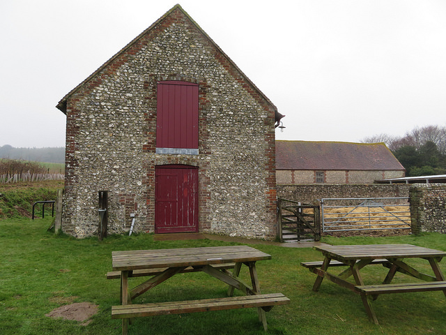 Stone barn, with wooden benches in front of it