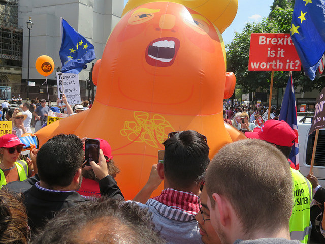 A Baby Trump balloon, orange and snarling