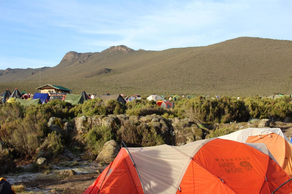 A wider view of the campsite, with hills in the background