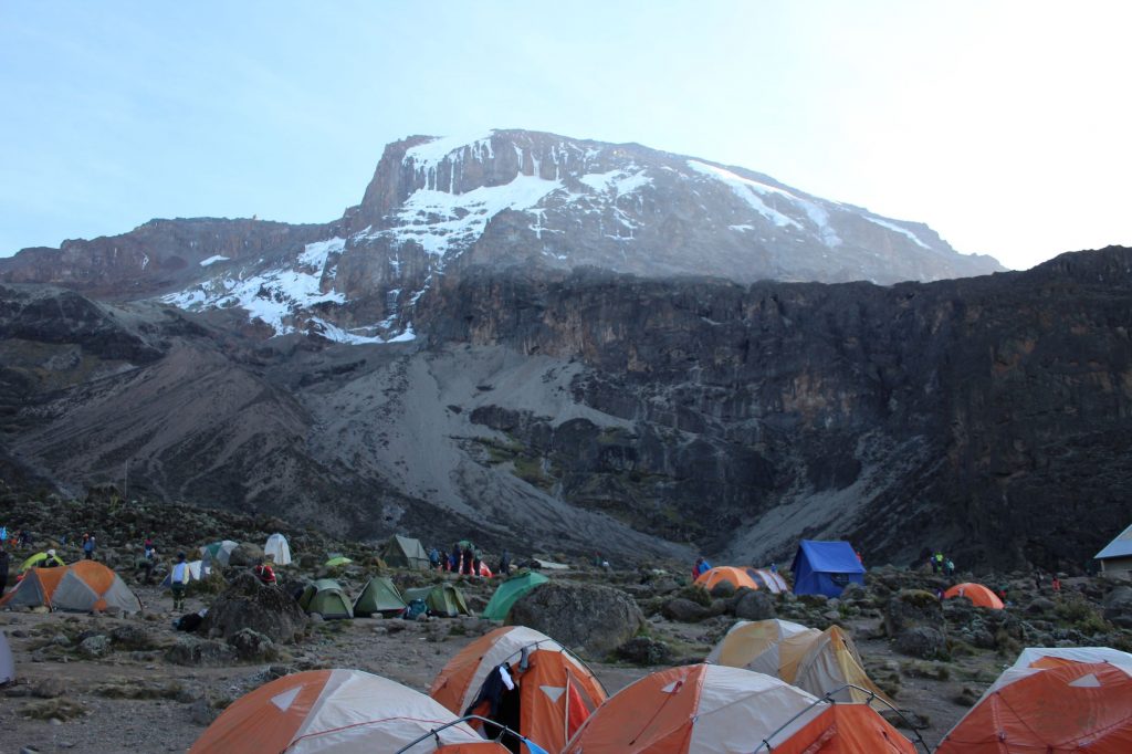 View over campsite, with the Baranco wall cliff at the back of the Camp.  Mountain peak behind