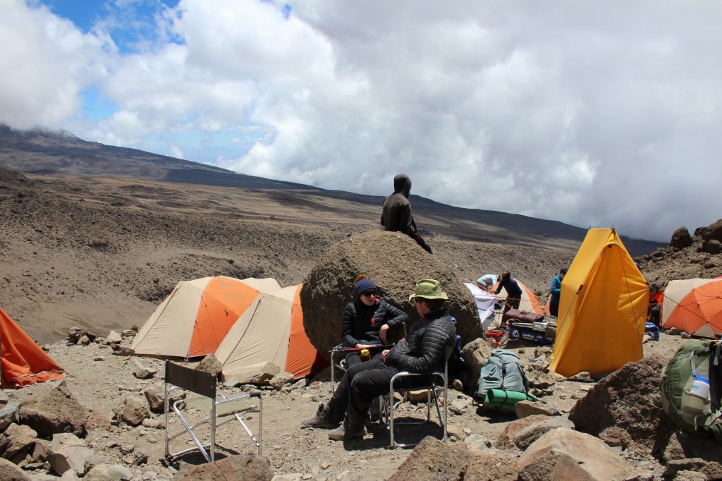 Some of the team sitting in chairs in the final campsite