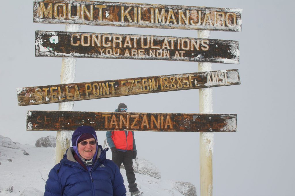 Me at Stella Point, in front of sign showing altitude of 5756m