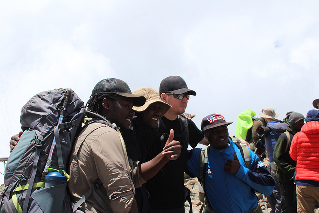 One of the team taking a photo with three of our guides