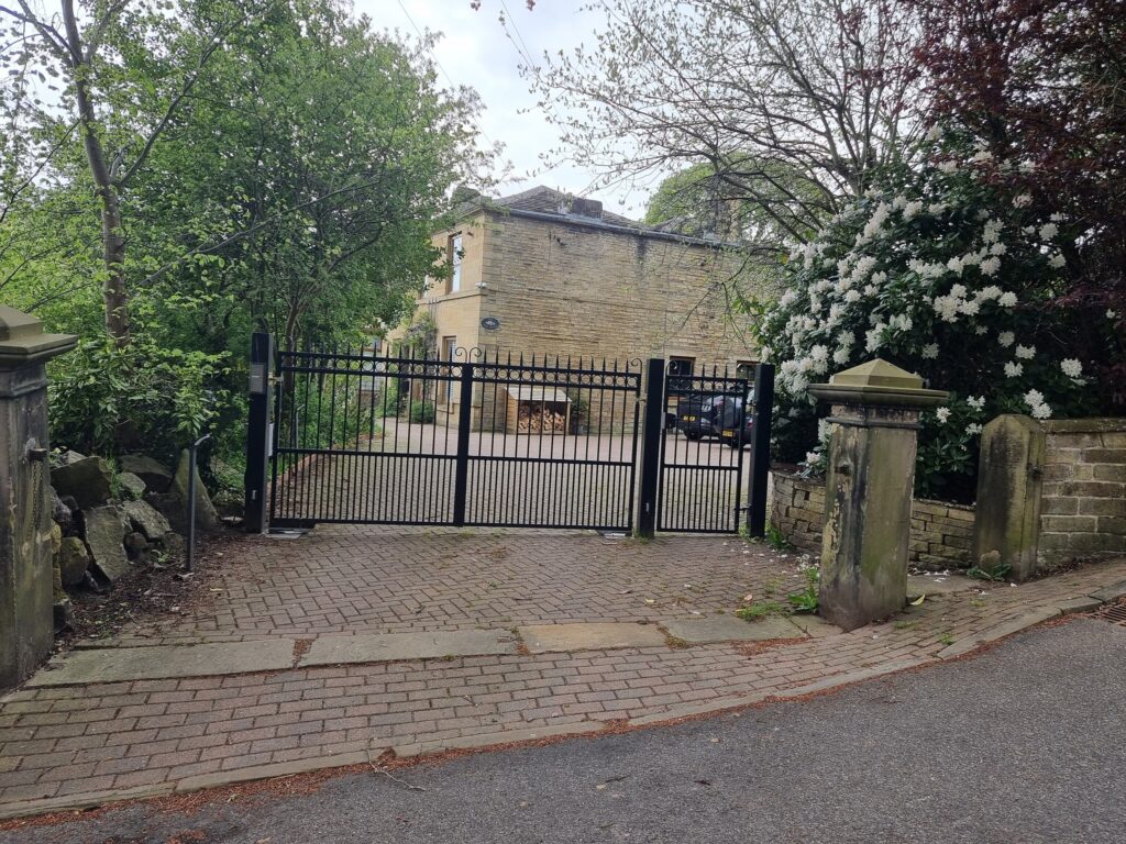 Image through a pair of iron railing gates of a house
