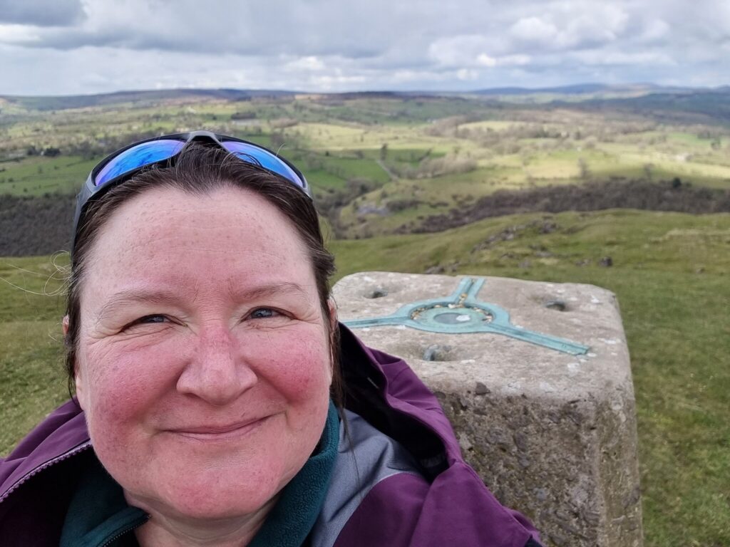 Selfie of me, with trig marker behind me