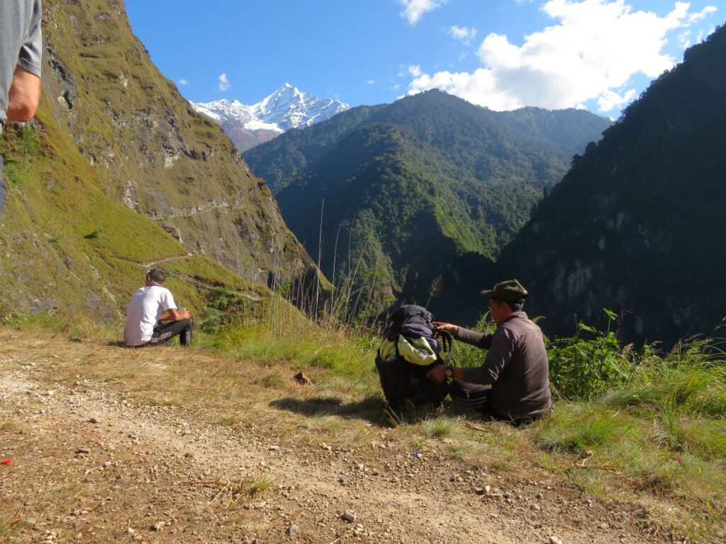 Sitting by path Two of the team overlook the valley