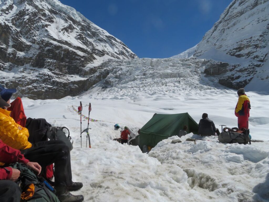 snowy camp, with paths though the snow showing depth of 1m+  One tent set up only