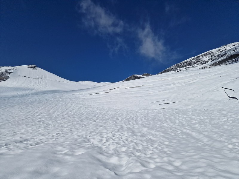 Looking up the snowy slope we're about to climb,, bright blue skies